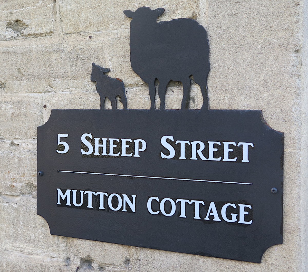 Sheep, a street, and a&nbsp;home